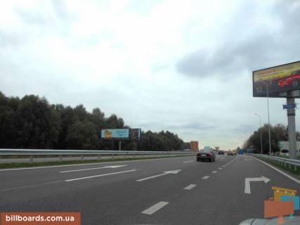 Билборд B в Ходосовке, 12х3  Дніпровське шосе, траса Н-01 "Київ-Знам'янка", км 23+950 ліво, через 300м після повороту на с. Ходосівку та АЗС UPG, навпроти ТЦ "МегаМаркет", правий фото 1